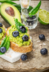 Sandwiches with avocado, blueberries and spinach