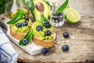 Sandwiches with avocado, blueberries and spinach