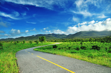 Country road against blue sky background