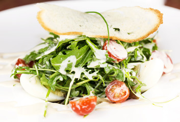Fototapeta na wymiar salad greens and eggs on a white dish at restaurant