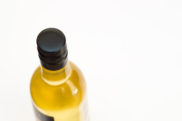 Bottle of liquid in upper view with black metal cup on it