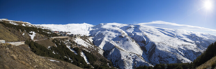 Panorama of snow mountain landscape with blue sky from Sierra Ne