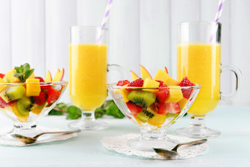 Fruit salad with mint and orange juice in glassware