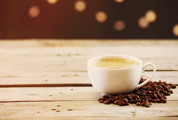 Cup of coffee on table on brown background