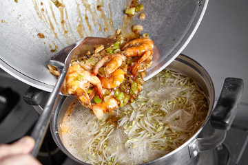 Adding the stir fried to the soup