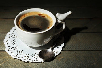 Cup of coffee on rustic wooden planks background