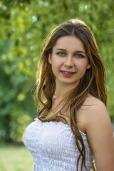 Fototapeta premium girl with long hair embraces a birch