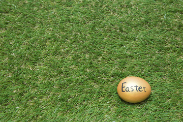 Gold easter egg on green grass