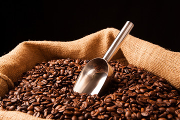 roasted coffee beans with scoop in bag