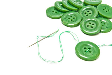 green thread and buttons on white