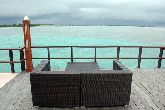 Brown couch at timber pier ocean view