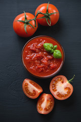 Above view of chopped tomatoes over black wooden surface