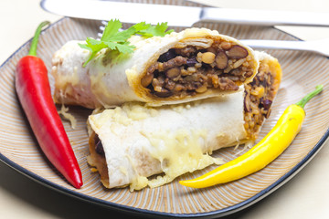 burrito filled with beef minced meat and beans baked with gouda