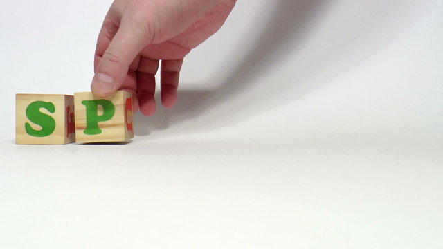 The video shows Spanish word built of wooden blocks