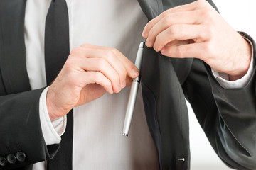 Businessman removing a pen from his pocket