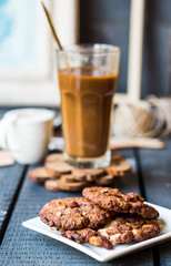 coffee with milk in a glass with a chocolate chip cookie