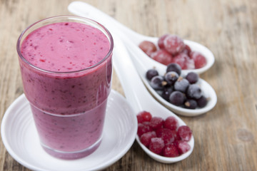 Smoothies from frozen black currant, red currant and gooseberry