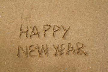 Fototapeta premium Happy New Year Message on Sand