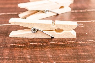 Wooden clothespins on wooden background
