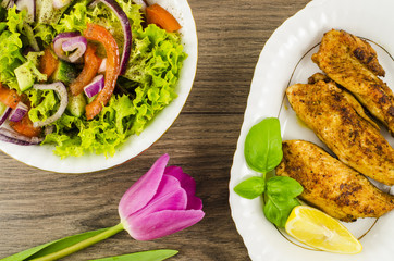 Fried chicken with vegetables salad and flower