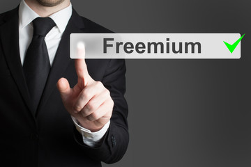 businessman pushing flat button freemium