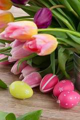 pink and violet tulips with easter eggs