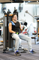 smiling man exercising on gym machine