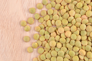 Close up of green lentil on wooden background