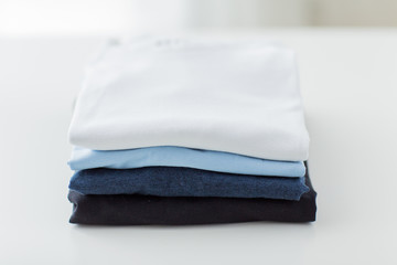 close up of ironed and folded t-shirts on table
