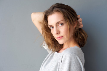 Elegant mid adult woman posing with hand in hair