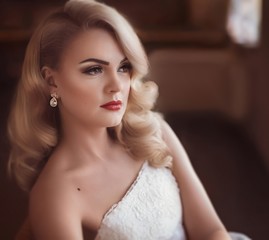 Beautiful bride blonde with stylish make-up in white dress