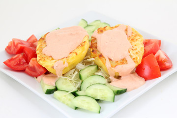 delicious baked potatoes with sauce and vegetables