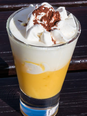 liqueur with whipped cream and cocoa powder, eggnog