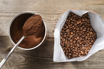 coffee beans and ground coffee on wooden background