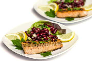 Salmon fillet grilled with bean salad, lemon and parsley