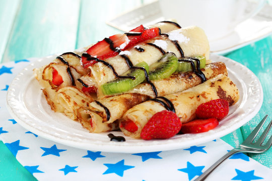Delicious pancakes with strawberries and chocolate
