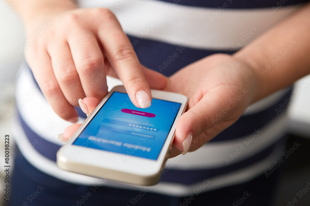 Wall mural female hands using mobile banking