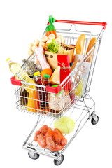 Shopping cart full with various groceries isolated on white