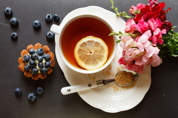 cup of tea with cake and flowers