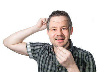 Man putting on mask of himself
