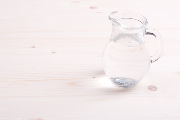 water in a glass and a napkin on the board