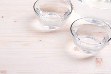 water in a glass and a napkin on the board