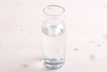 water in a glass and a napkin on the board