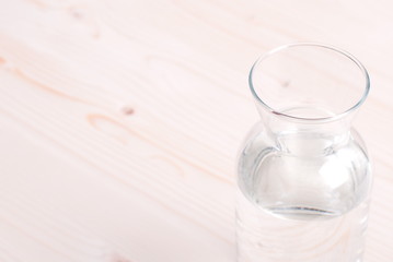 water in a glass and a napkin on the board