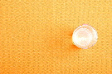 water in a glass and a napkin on the board