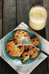 Cookies on plate with jar of condensed milk on wooden