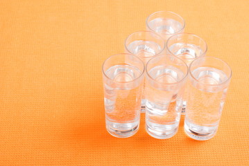 water in a glass and a napkin on the board