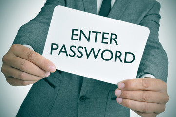 man in suit showing a signboard with the text enter password