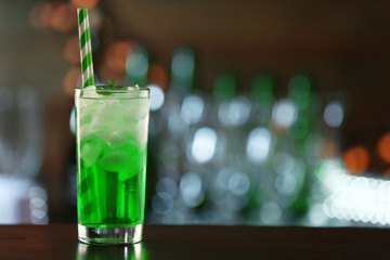 Green cocktail on table on dark background