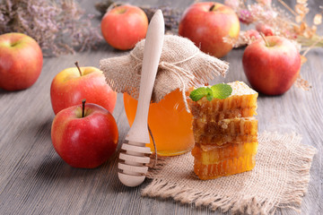 Delicious honey with apple on table close-up